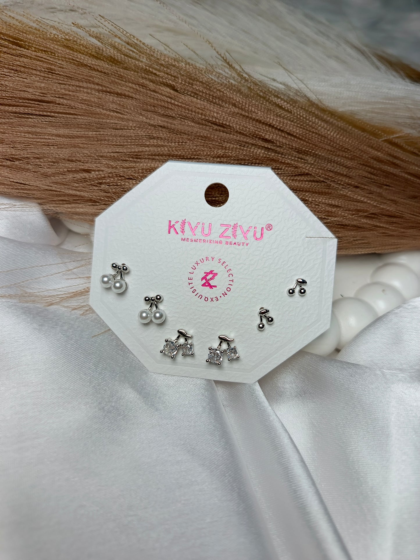 Add a touch of playful elegance to your jewelry collection with this stunning three-pair stud of earring set